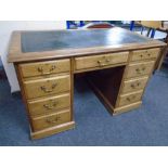 A 19th century mahogany twin pedestal writing desk with a green leather inset panel,