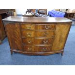 A mahogany bow fronted double door sideboard fitted with four central drawers and brass drop
