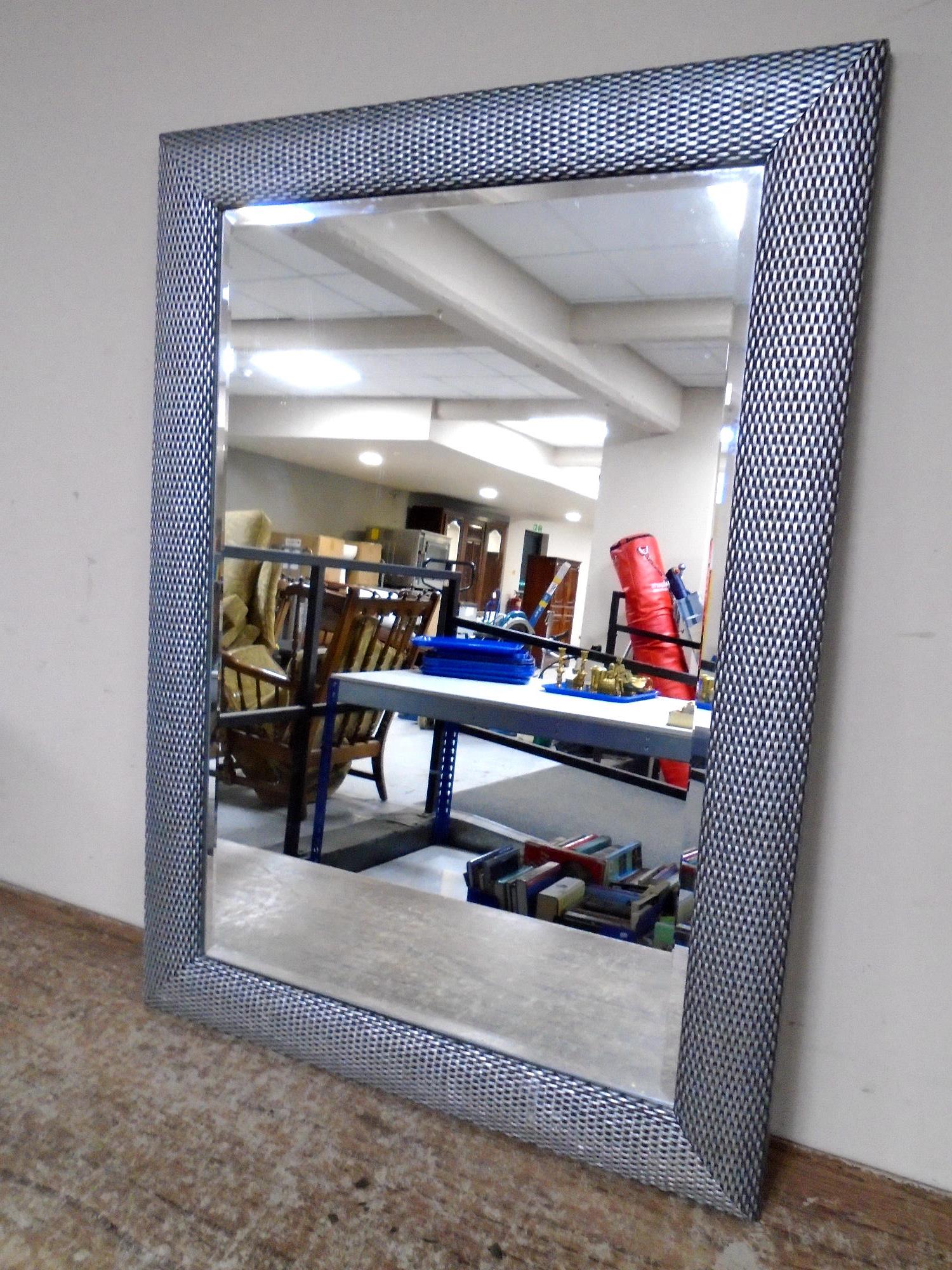 A contemporary overmantel bevel edged mirror in frame.