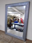 A contemporary overmantel bevel edged mirror in frame.