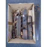 A box containing vintage woodworking tools including handsaws, block planes, drill bits etc.