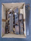 A box containing vintage woodworking tools including handsaws, block planes, drill bits etc.