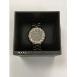 An encrusted wristwatch by Marc Jacobs, in retail box.