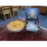 An Edwardian beech framed nursing chair upholstered in tapestry fabric together with a circular