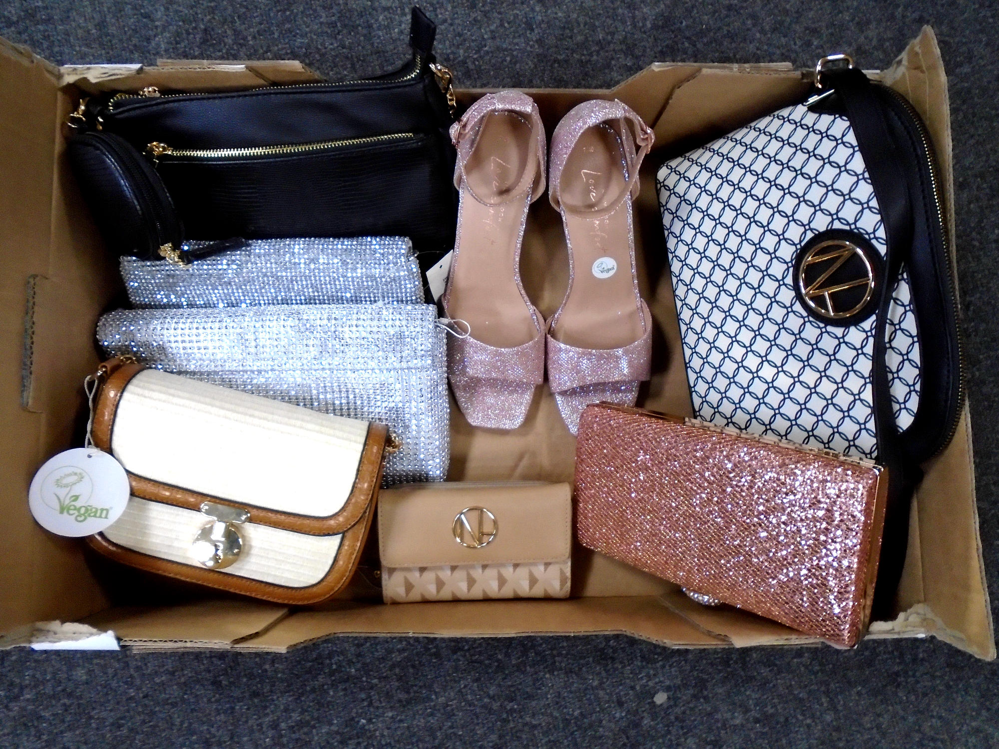 A box containing assorted lady's hand and clutch bags, New Look shoes (new with tags).