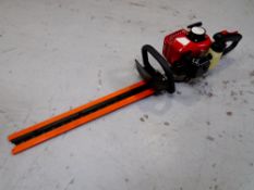 A petrol hedge trimmer.