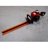 A petrol hedge trimmer.