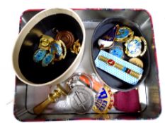 A tin containing United Nations enamelled badges, Steward medal, brass seal,