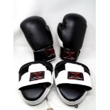 A pair of Max Strength boxing gloves with hand pads.
