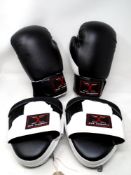 A pair of Max Strength boxing gloves with hand pads.