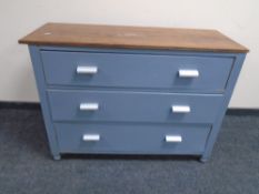 A wooden-topped painted three drawer chest.