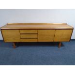 A mid-20th century Scandinavian low double door sideboard fitted with three drawers together with
