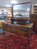 A Chapman's Siesta mahogany four drawer dressing table on raised legs (missing castor).