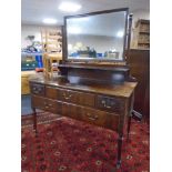 A Chapman's Siesta mahogany four drawer dressing table on raised legs (missing castor).