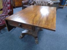 A 19th century mahogany flap sided table fitted with a drawer on four way pedestal.