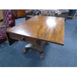 A 19th century mahogany flap sided table fitted with a drawer on four way pedestal.