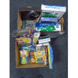 Two boxes containing new novelty toys, golf putting mat and chipping game etc.