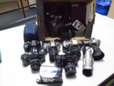 A box containing assorted cameras and equipment including Nikon F55 camera, Nikon F60 camera,
