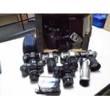 A box containing assorted cameras and equipment including Nikon F55 camera, Nikon F60 camera,