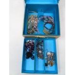 A jewellery box with key containing a small quantity of costume jewellery including beaded