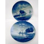 A pair of Dutch style blue and white porcelain wall plates.