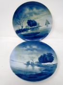 A pair of Dutch style blue and white porcelain wall plates.