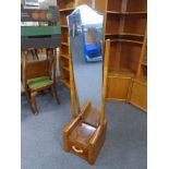 A narrow walnut Art Deco cheval mirror fitted with a drawer.