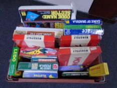A crate containing a quantity of assorted board games including Monopoly, Rat Race, Cluedo,