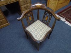 An inlaid mahogany corner armchair.