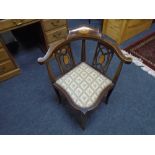 An inlaid mahogany corner armchair.