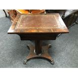 A Regency rosewood pedestal occasional table with a leather inset panel on claw feet.