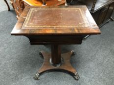 A Regency rosewood pedestal occasional table with a leather inset panel on claw feet.
