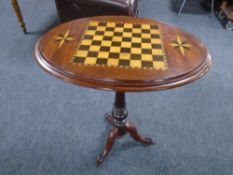A 19th century mahogany tilt top chessboard occasional table on three way pedestal.