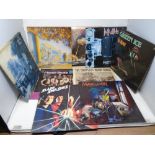 A box containing approximately 38 LPs including Moody Blues, Queen, Magnum, Bill Wyman, Marillion,