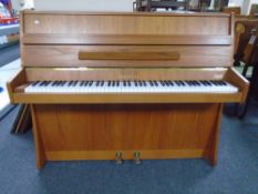 A Chappell teak cased overstrung mini piano with storage stool.