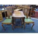 An Edwardian oak gate leg table together with a set of four Queen Anne style chairs.