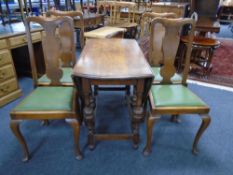 An Edwardian oak gate leg table together with a set of four Queen Anne style chairs.