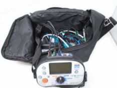 A Kewtech KT63 multifunction tester with leads in carry bag.