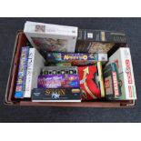A crate containing a quantity of board games and jigsaws including Operation, Monopoly,