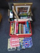 Two boxes containing enamelled wall signs, assorted games, hardcover books, prints etc.