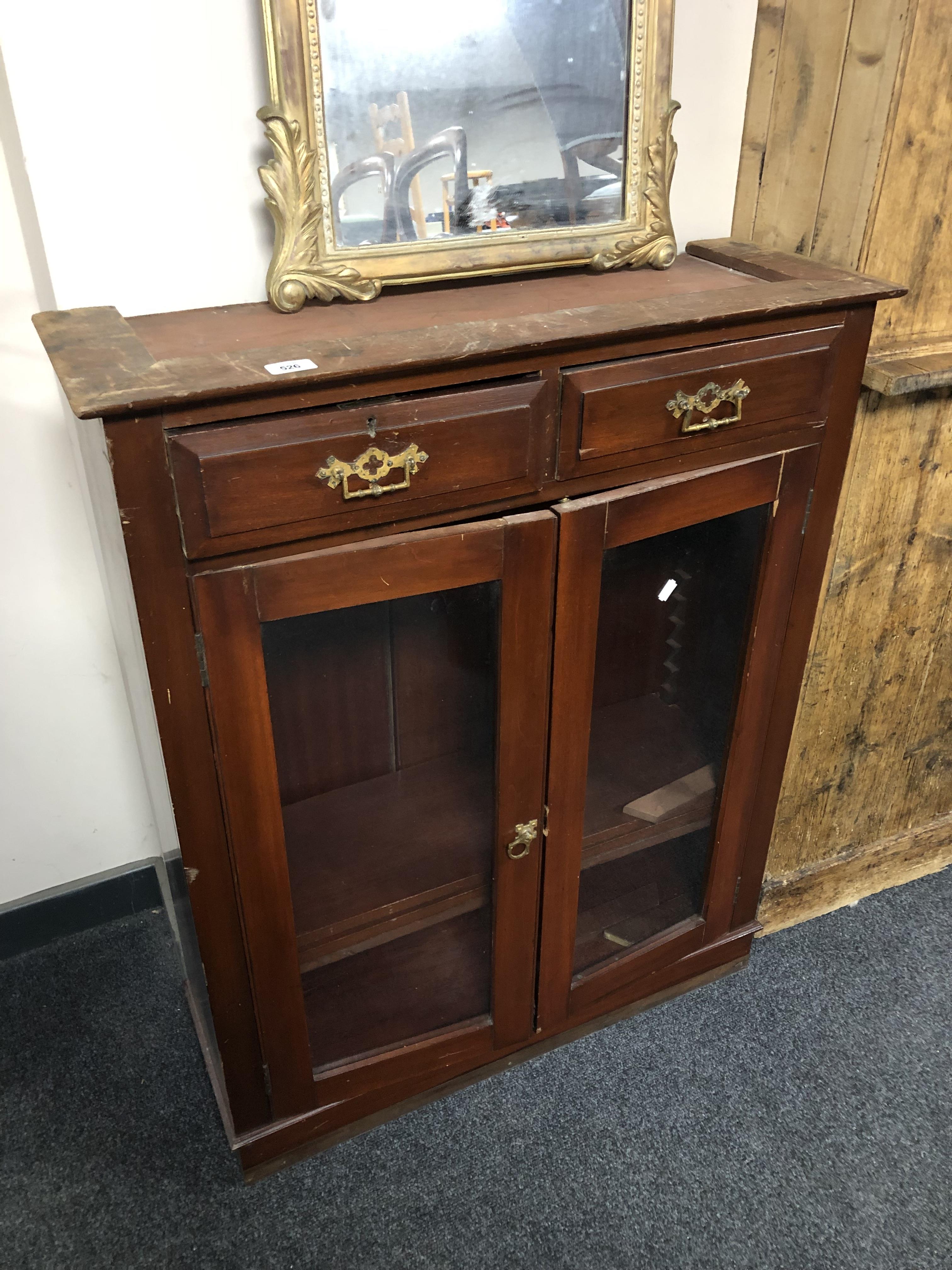 A part 19th century mahogany double door bookcase fitted with two drawers above.