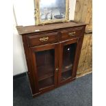A part 19th century mahogany double door bookcase fitted with two drawers above.
