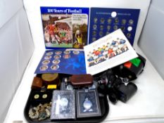 A tray containing FA Cup centenary and Top Team collectors albums, Atlas pocket watches, cap badges,