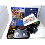 A tray containing FA Cup centenary and Top Team collectors albums, Atlas pocket watches, cap badges,