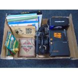 A box containing vintage bakelite telephone handset, Monopoly game,