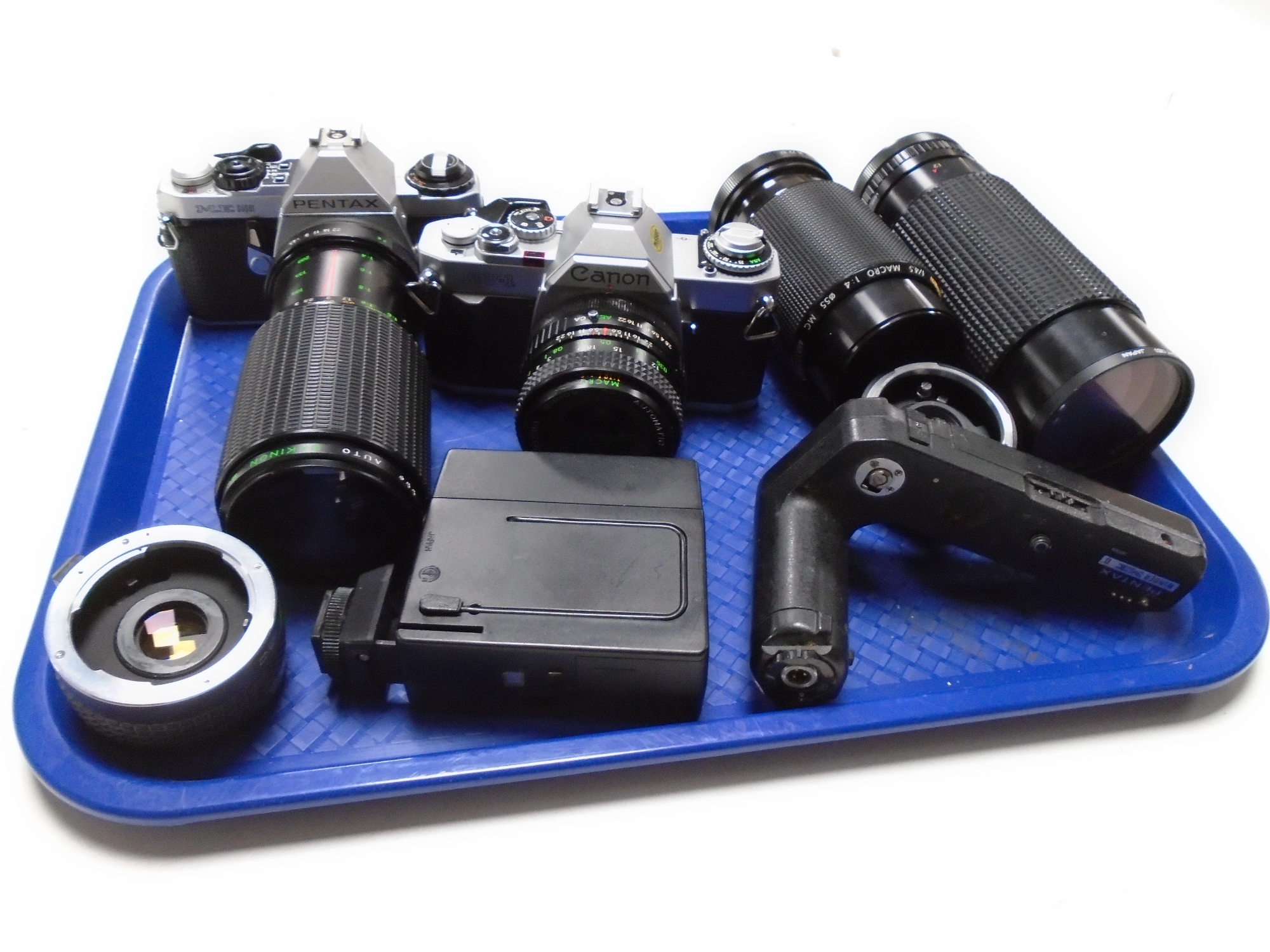 A tray containing Pentax ME Super camera, Canon AV-1 camera,