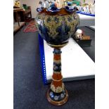 A Royal Doulton Lambethware pottery jardiniere on stand (height 101cm).
