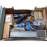 A box containing Hornby/Triang OO gauge trains and buildings.