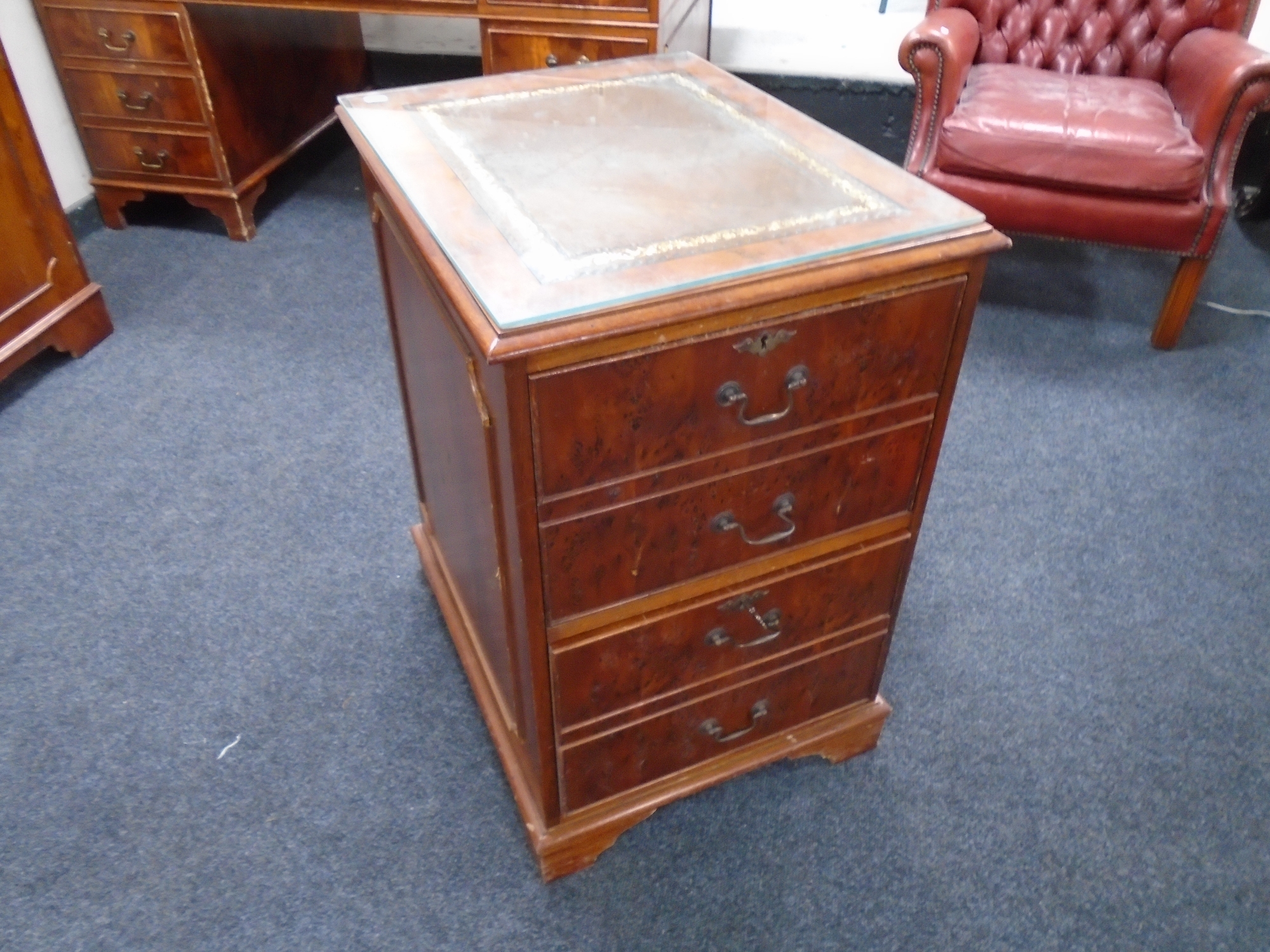 A yew wood two drawer filing chest with a brown leather inset panel.