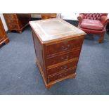 A yew wood two drawer filing chest with a brown leather inset panel.